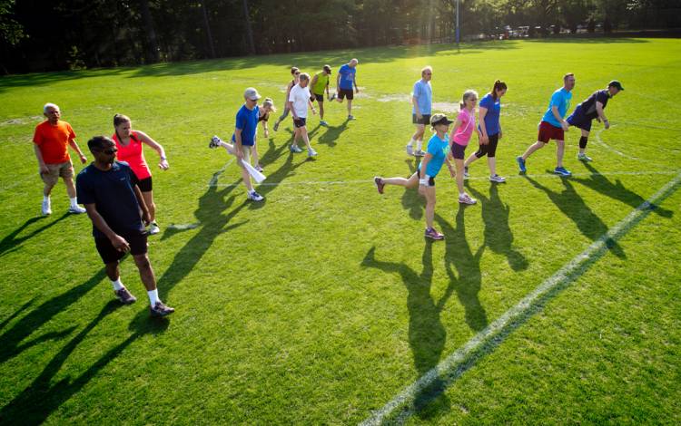 Members of the Run/Walk Club stretch before a workout.