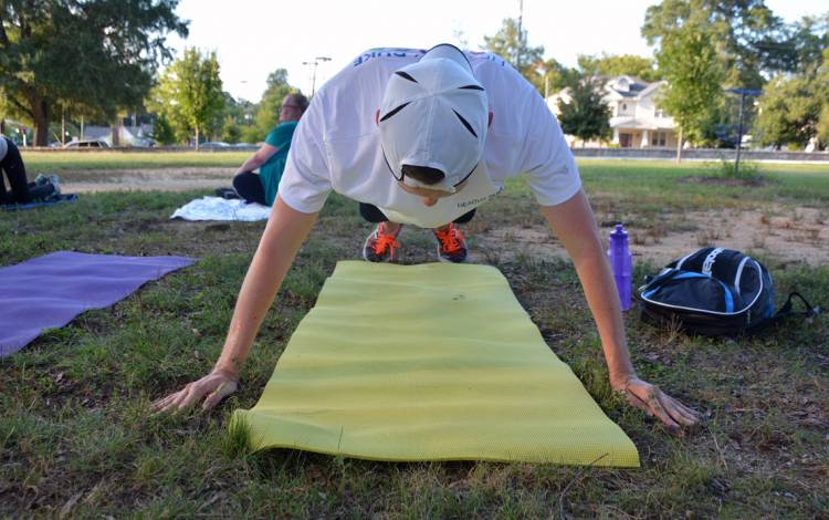 A member of the Run/Walk Club does a push-up during the club's weekly strength class.