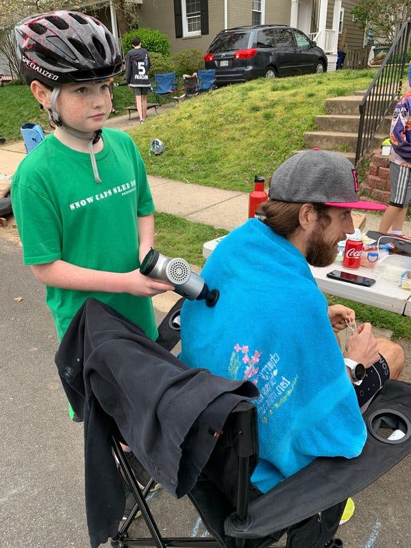 Wardian getting a muscle treatment from his 11-year-old son, Grant, on a brief break between laps.