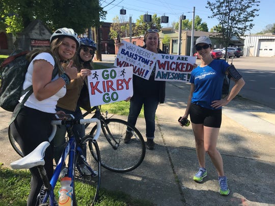 The Courier Journal's Kirby Adams was cheered on by Jordan Grantz (far left), Elliott Grantz (left) Alene Day (center) and Jen Board (right) along the Boston Marathon Louisvlile Edition Race course on Monday April 20, 2020